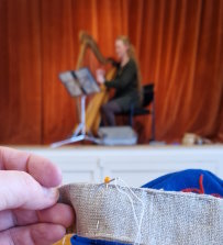 Sewing a carrying strap while listening to live harp music